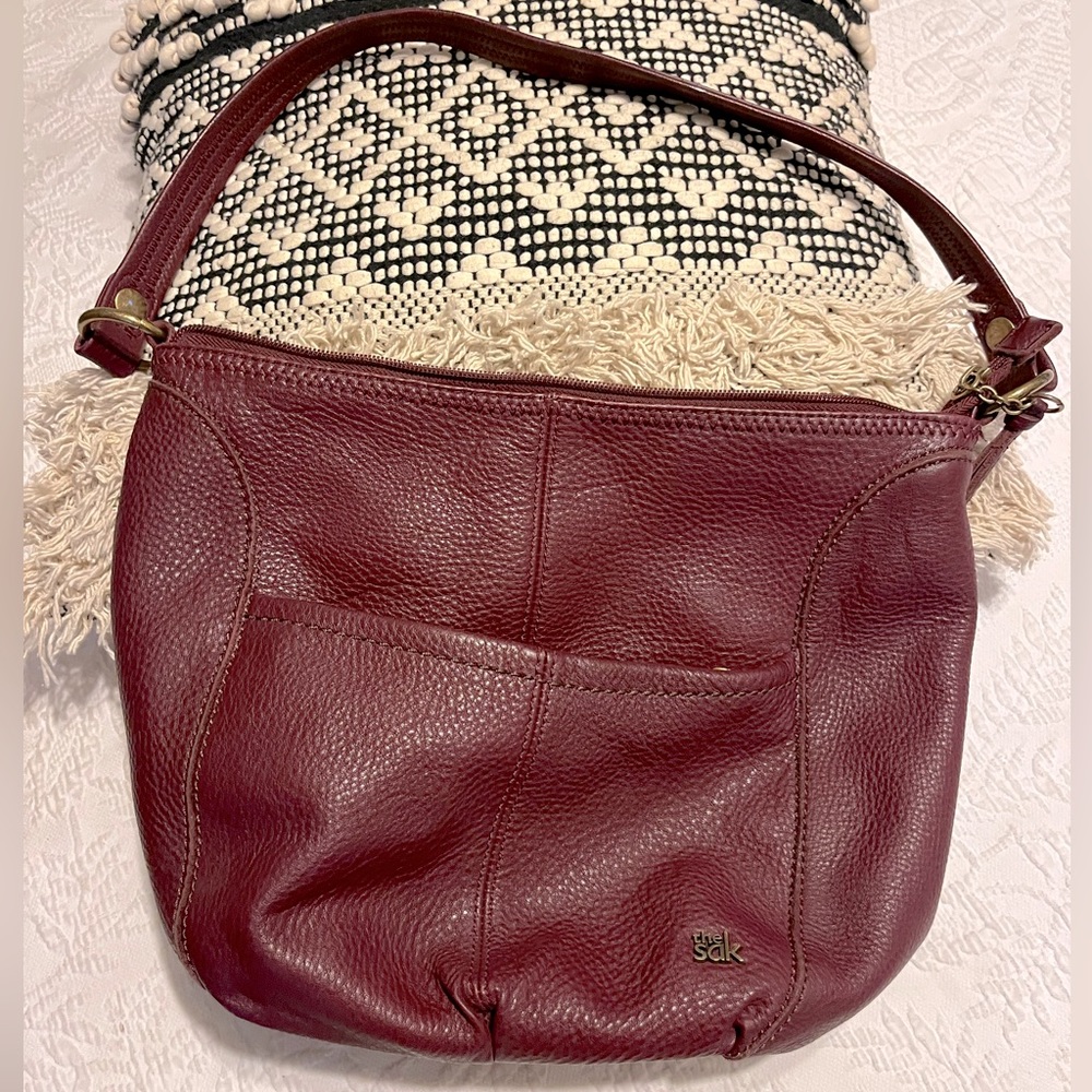 The Sak burgundy colored pebbled leather hobo bag